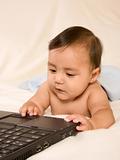 Baby boy browsing internet on his mother laptop
