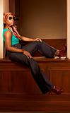 Urban African-American woman in jeans sitting 