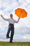 Happy businessman with orange umbrella