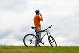 Man with mountain bike talking on cell phone