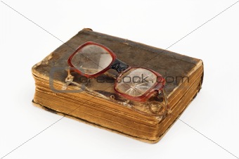 broken eyeglasses and book