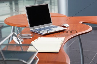 Laptop for planning at the modern office table