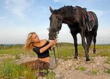 teenager and black stallion in nature